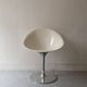 Ero swivel armchair in metal and white shell, p. starck design for kartell