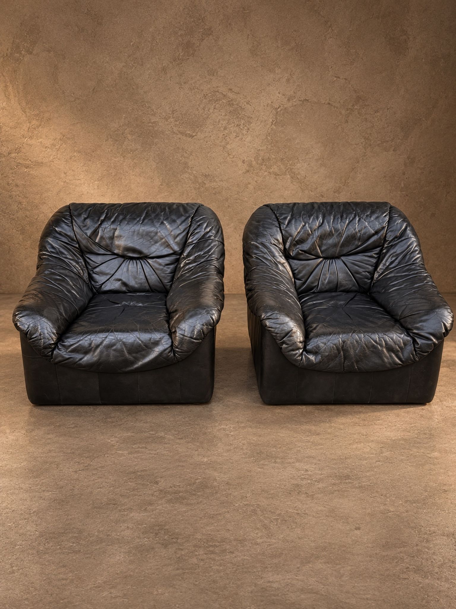 Leather armchairs and matching pouf, Italy, circa 1980