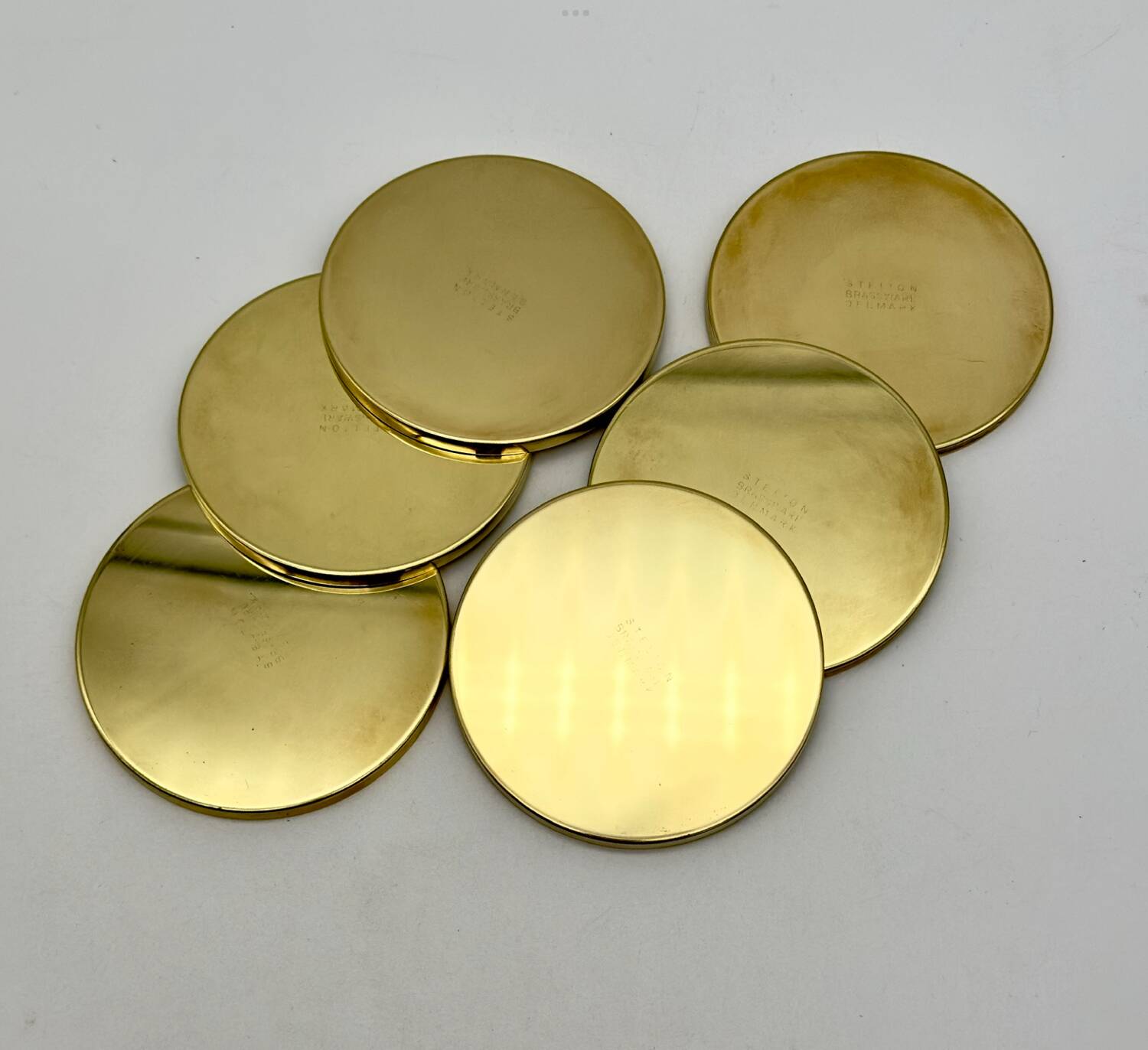 6 Coasters. Stelton. Brass