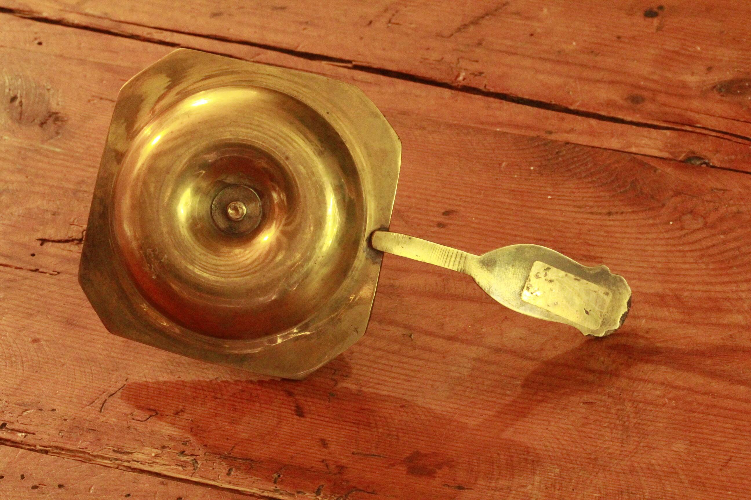 Old brass hand candle holder