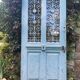 Entrance door in solid oak, cast iron grille, 1930s