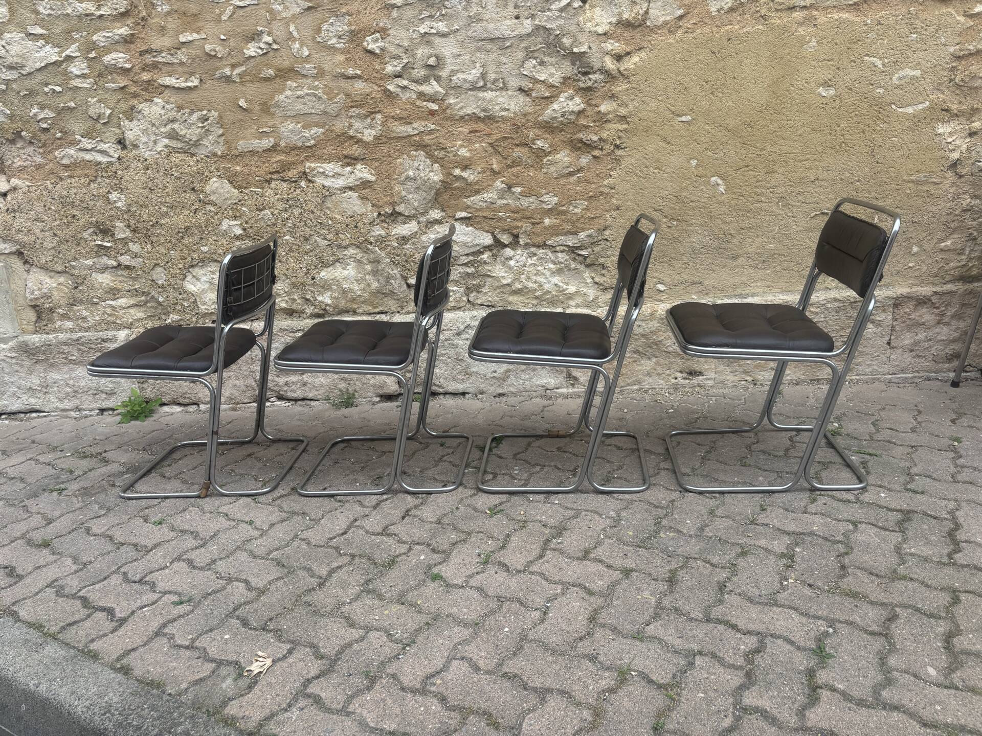 Four vintage chairs from the 1960s and 1970s, chrome with faux leather.
