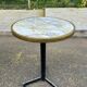 Round bistro table with a central pedestal, gold marble effect and black steel, 60cm.