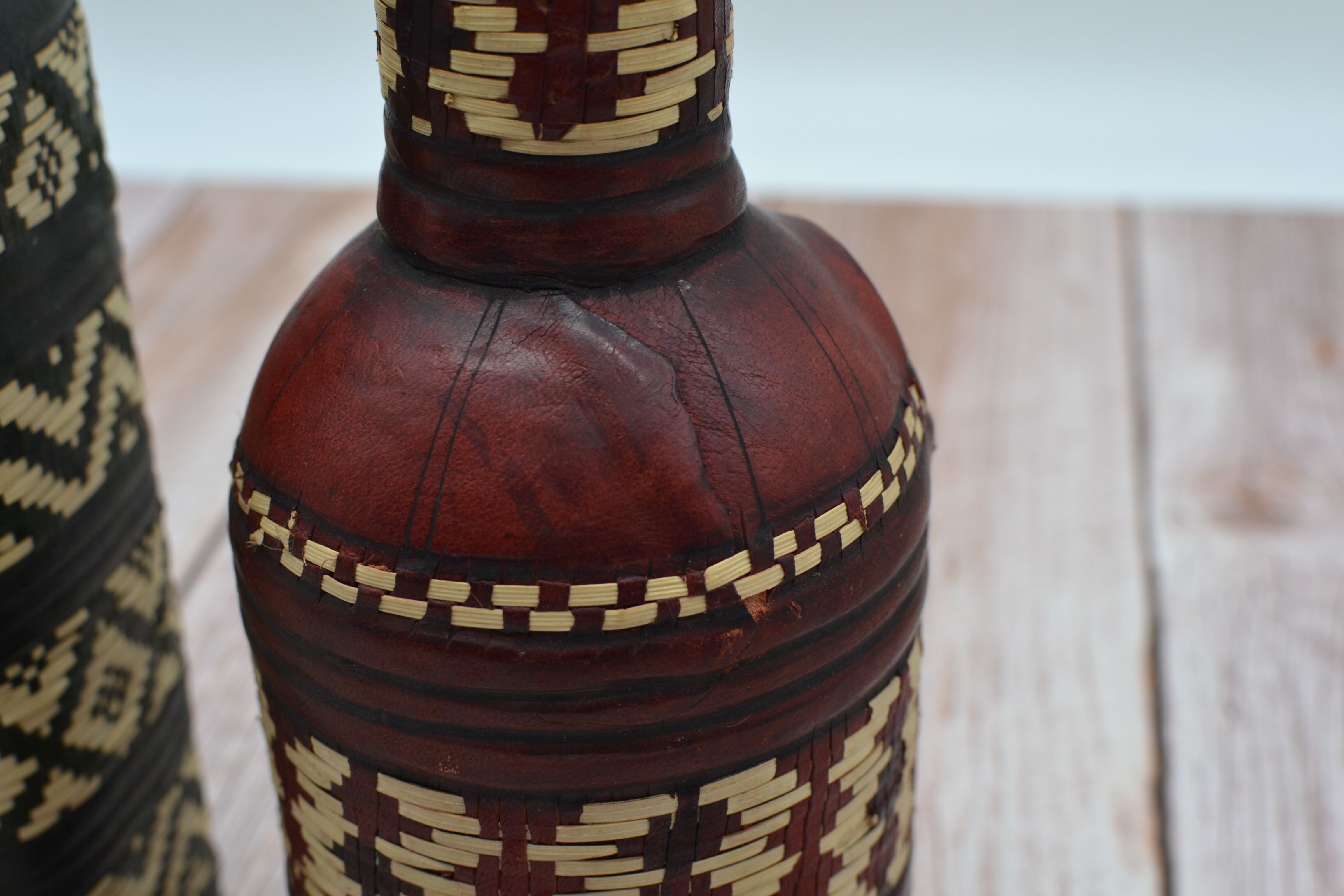 Set of 2 decorative vintage bottles covered with leather & wicker