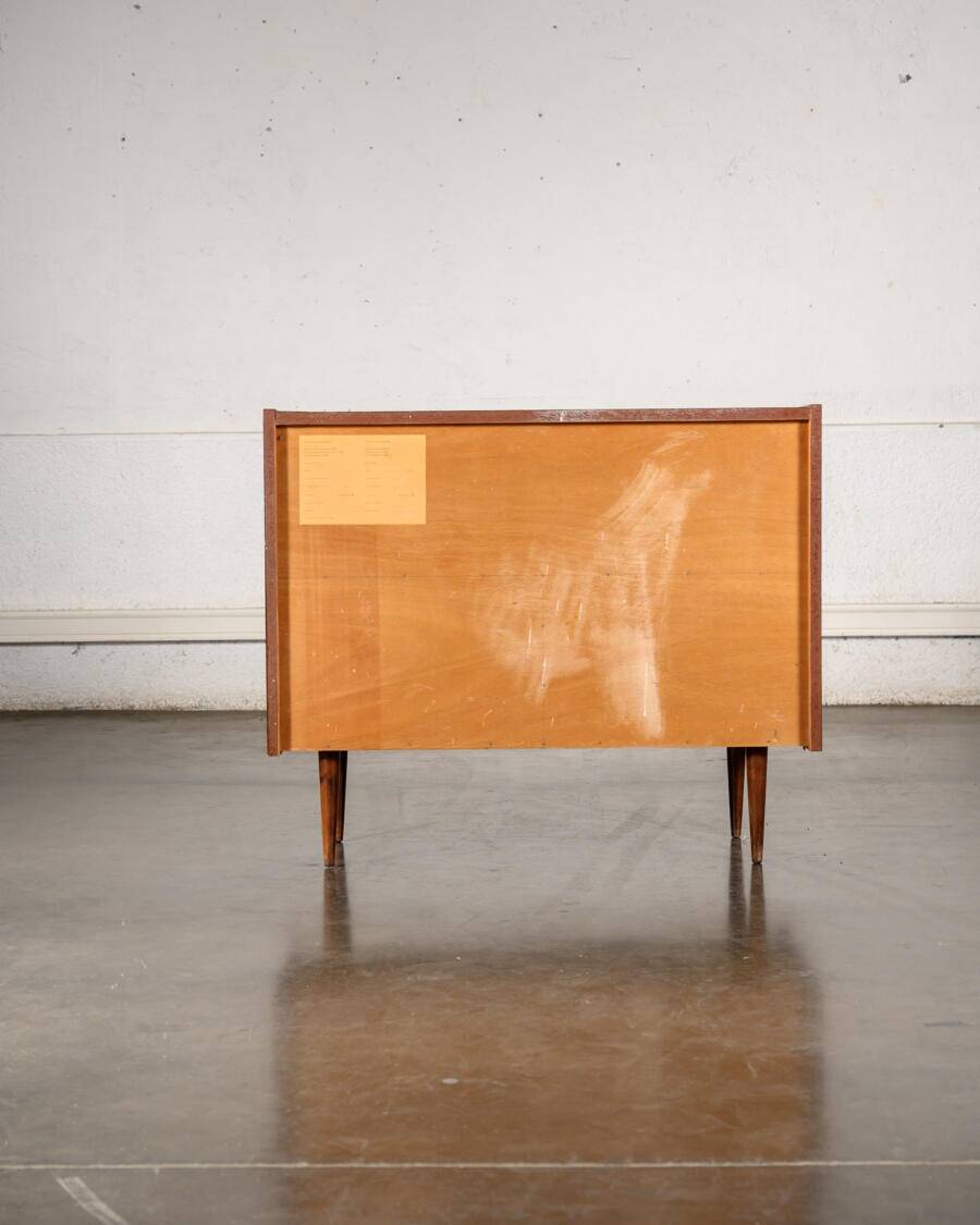 Old TV cabinet with brass handles.