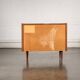 Old TV cabinet with brass handles.