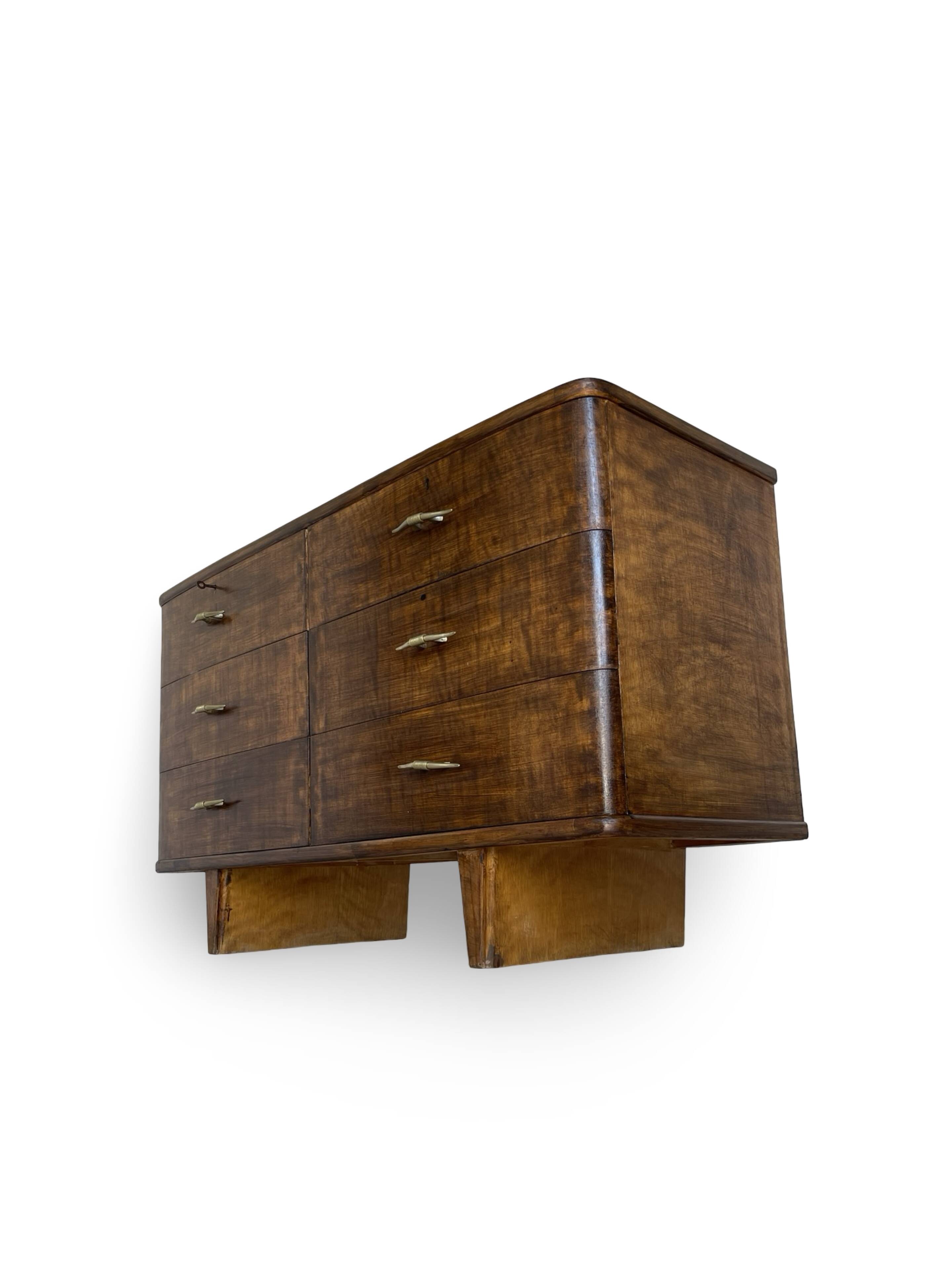 A vintage Italian chest of drawers, made of veneered walnut and solid wood,