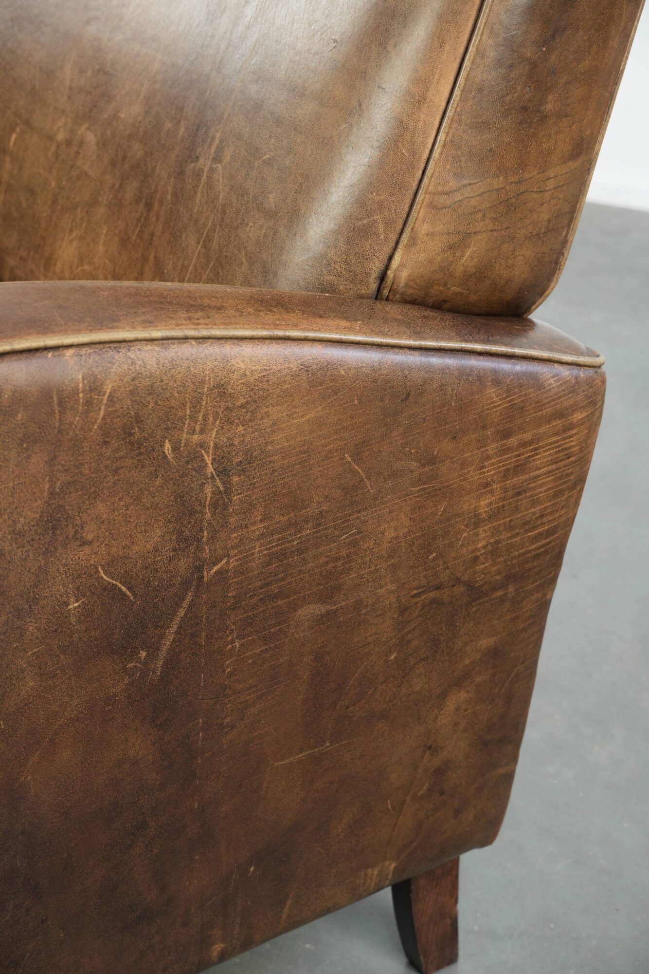 Set of a sheepskin armchair and ottoman finished with matching piping
