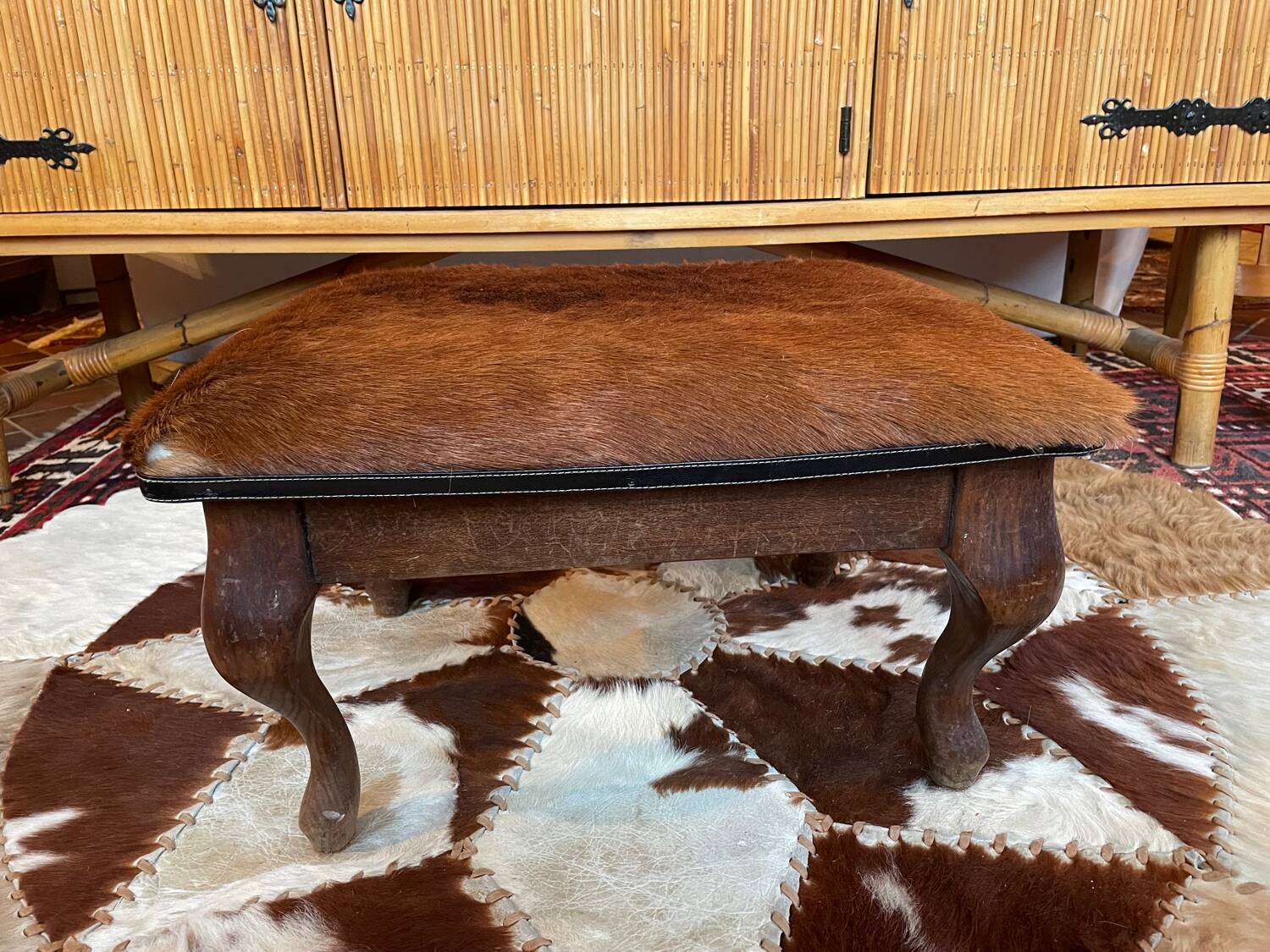 Vintage wooden and goatskin pouf