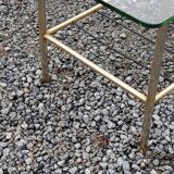 Vintage coffee table in gold and blackened metal with glass top from the 60s