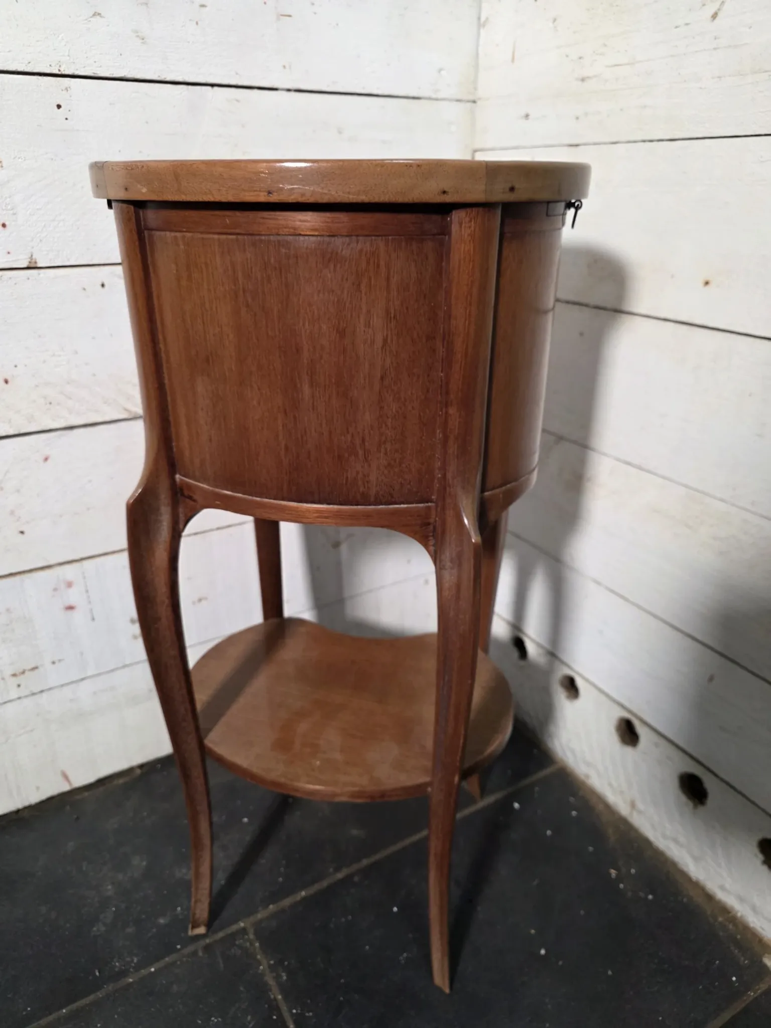 Oval bedside table in Louis XV style made of mahogany.