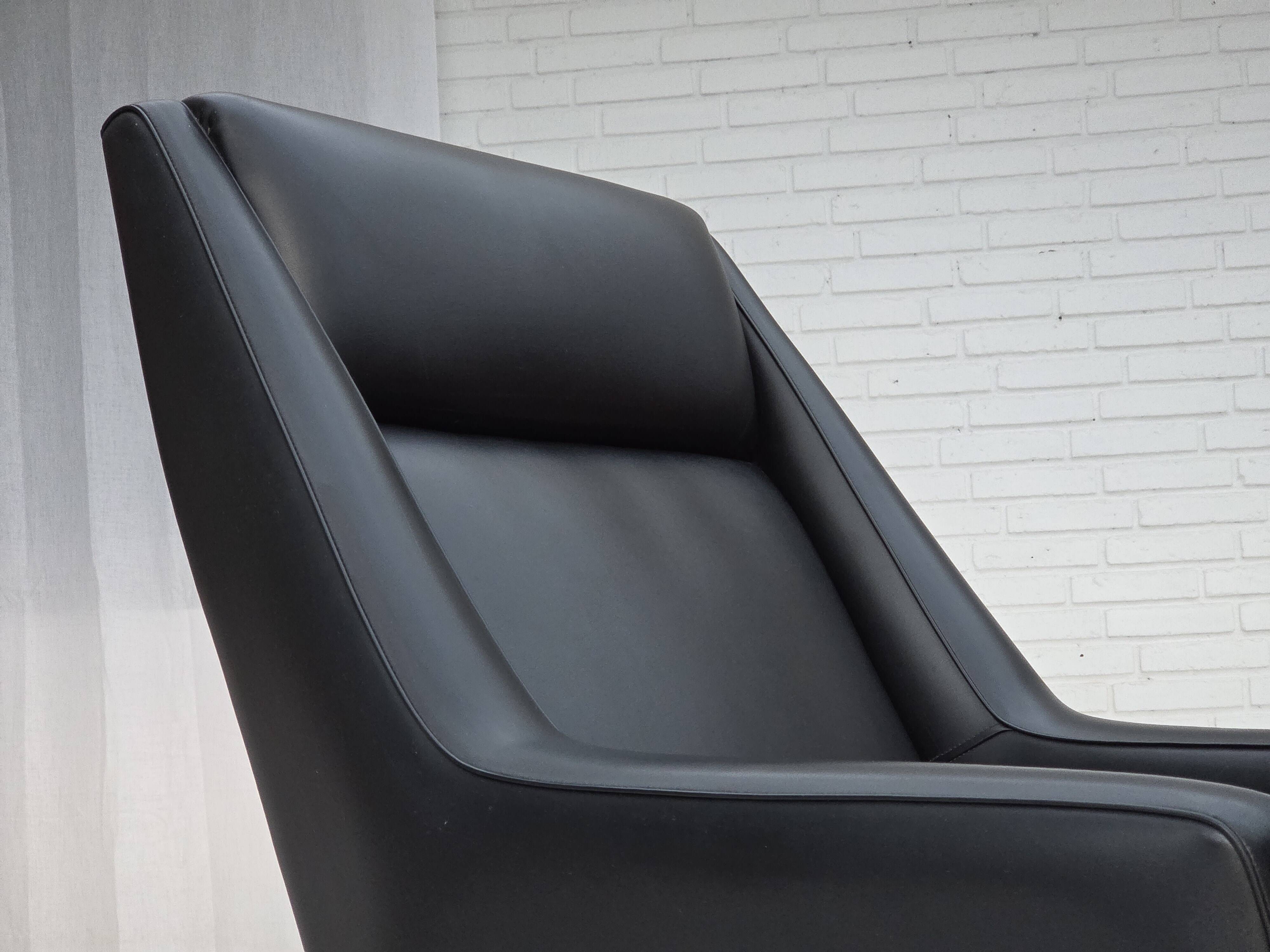 1970s, Danish highback armchair, black artificial leather, teak wood legs.