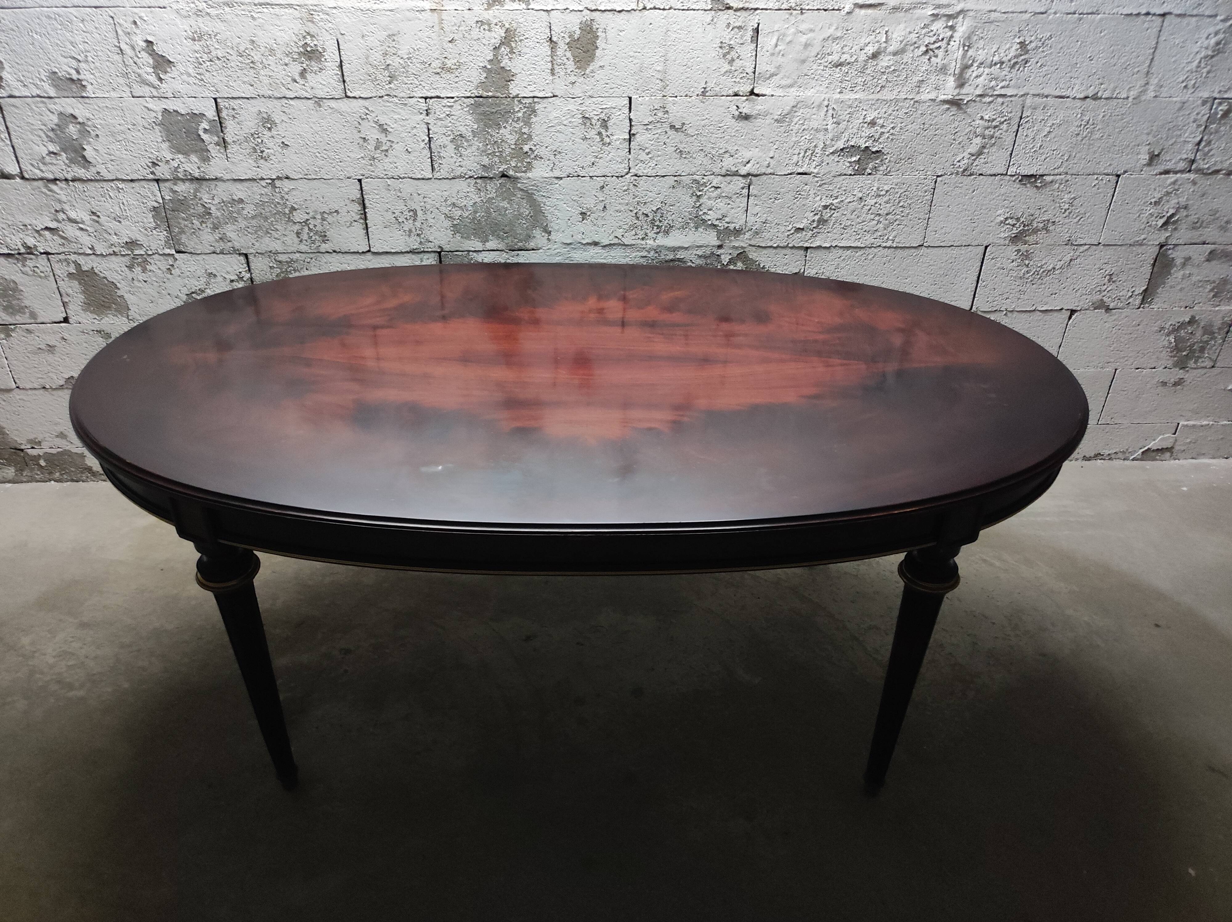 Oval Louis XVI style table with half-moon extensions.