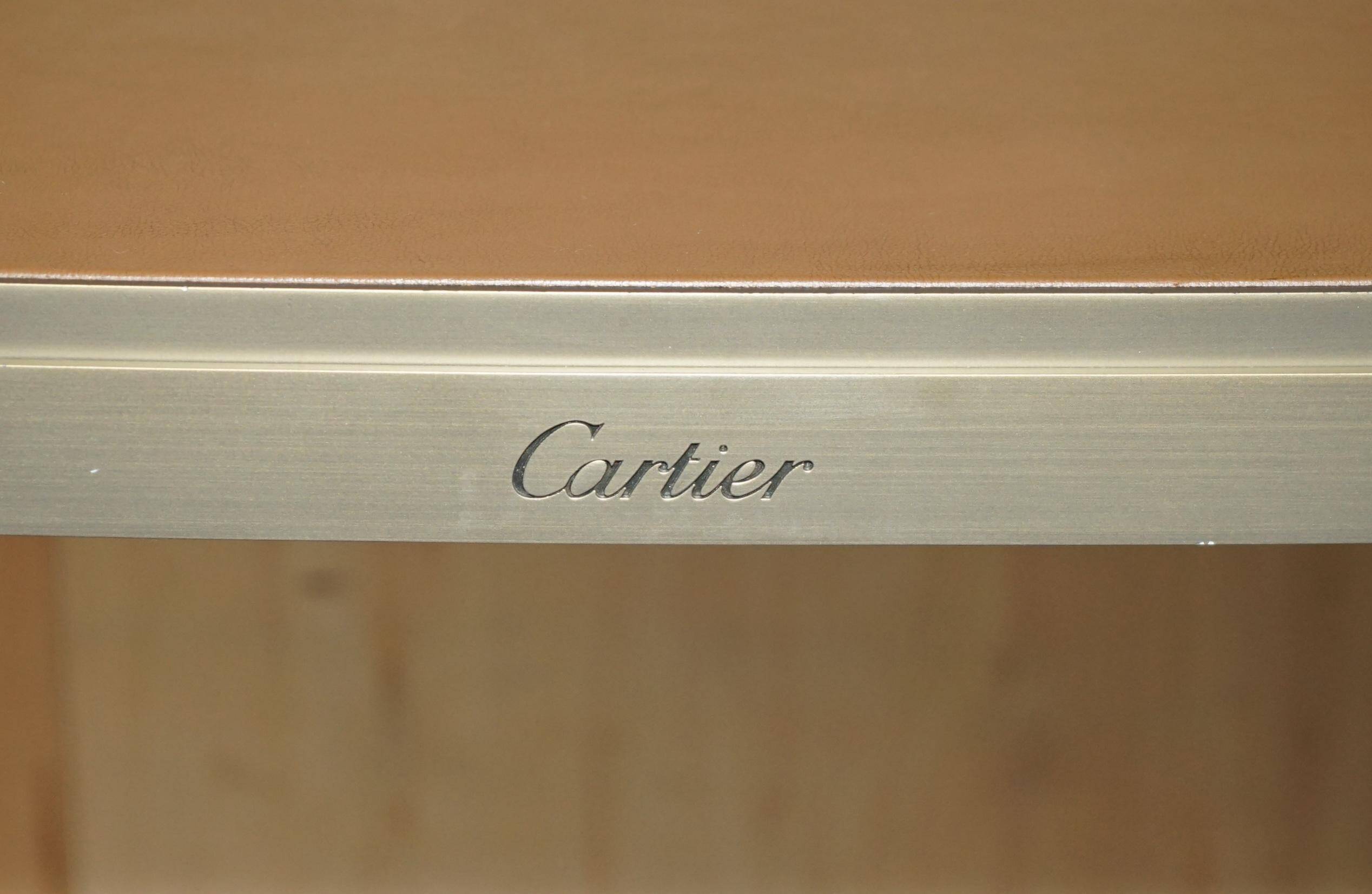 Modern mid-century writing desk signed Cartier in bronze and leather.