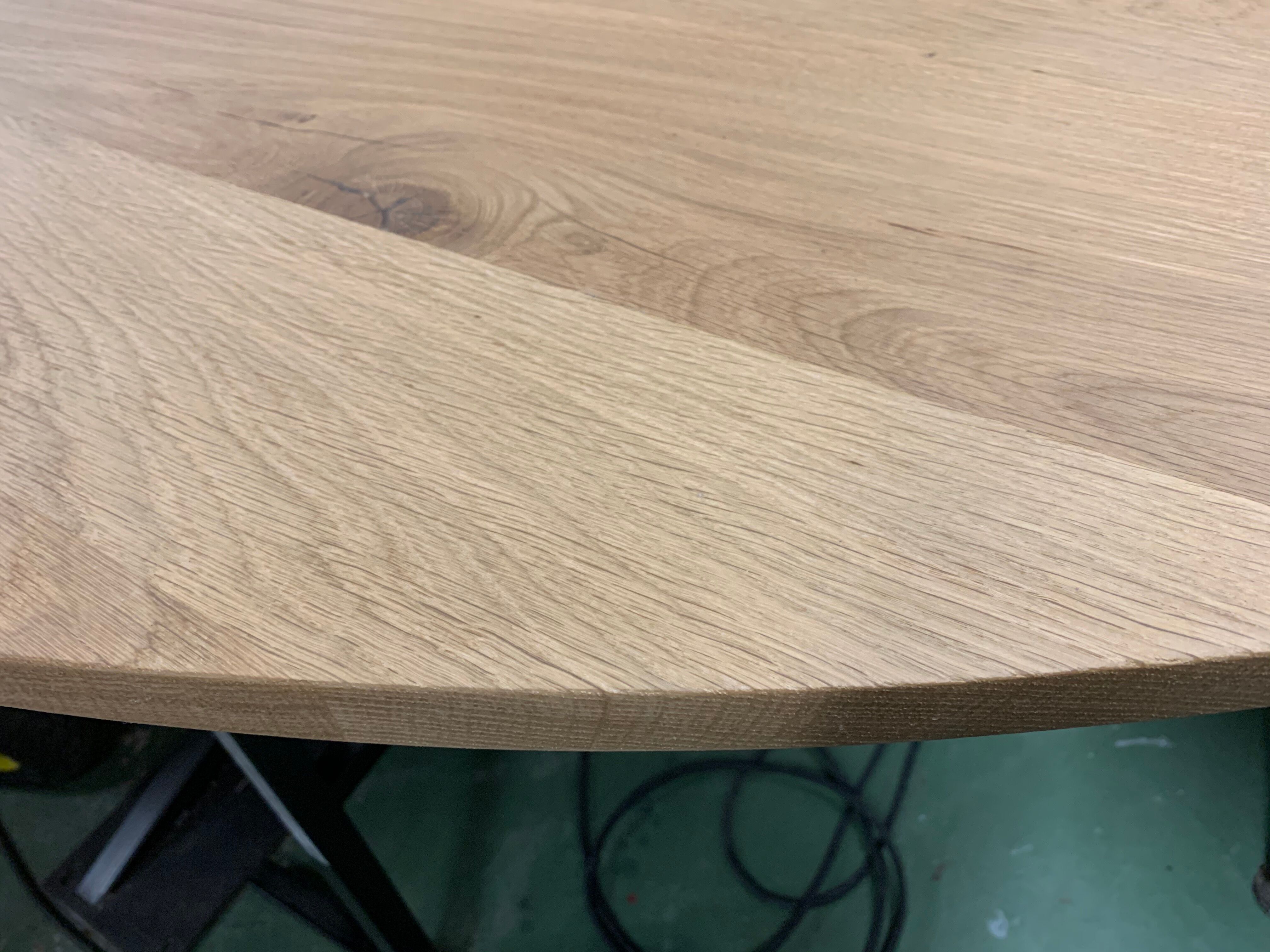 Oval table in solid oak refined edges with central foot in black metal