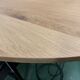 Oval table in solid oak refined edges with central foot in black metal