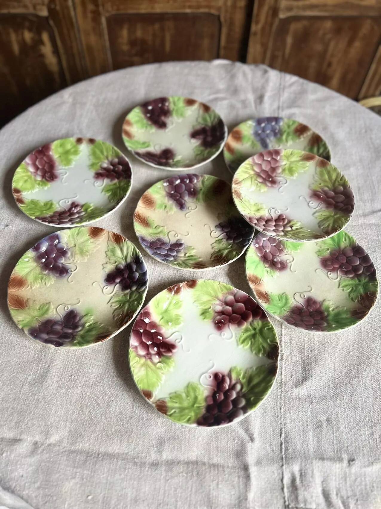 Set of eight flat dessert plates in barbotine earthenware with grape decoration – circa 1900.