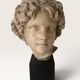 Plaster bust on a wooden base