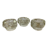 Set of three thick moulded glass candle holders.