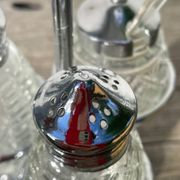 Silver-plated metal and glass salt and pepper shakers