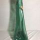Old green molded glass bottle with rounded shape