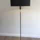 Designer floor lamp in black lacquered metal and brass