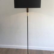 Designer floor lamp in black lacquered metal and brass