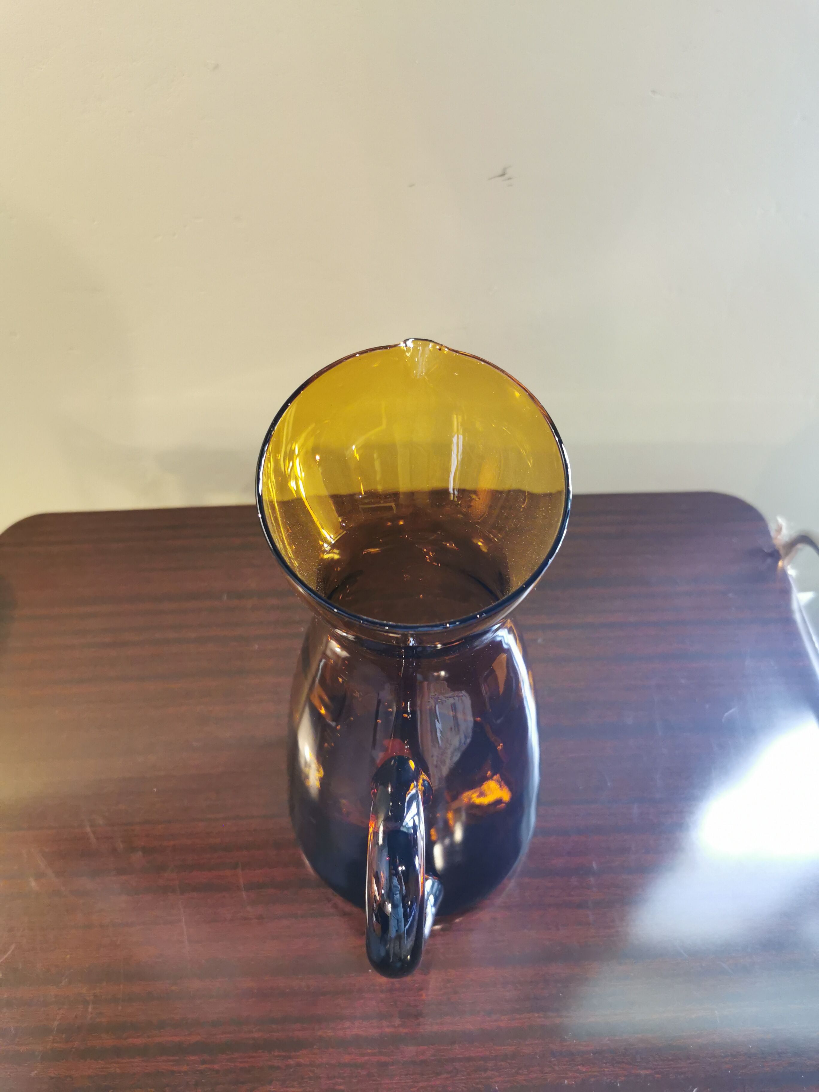 Vintage pitcher in amber glass
