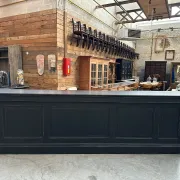 Immense bar counter covered with blue stone.