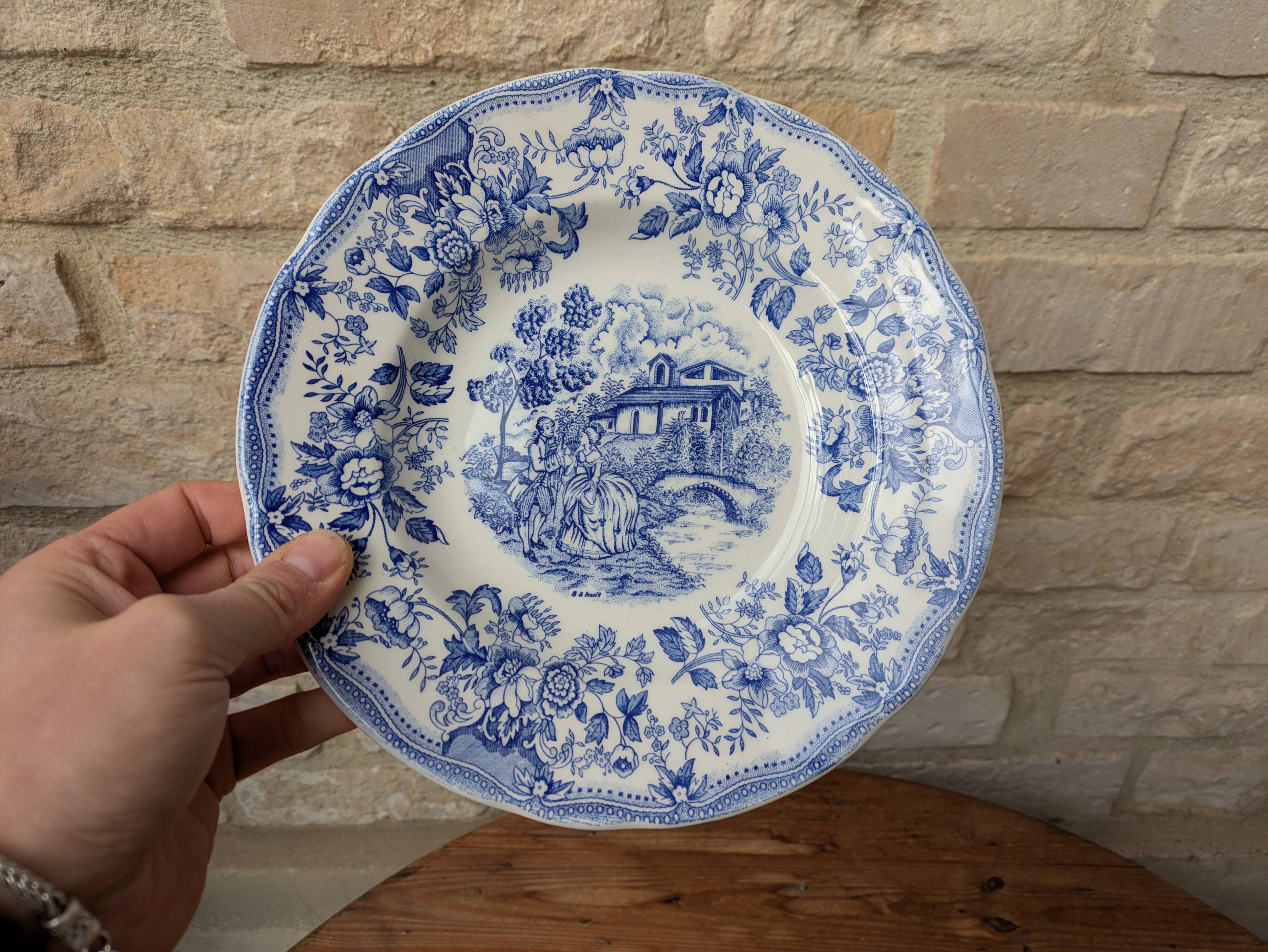 Old deep plate with blue floral pattern and gallant scene