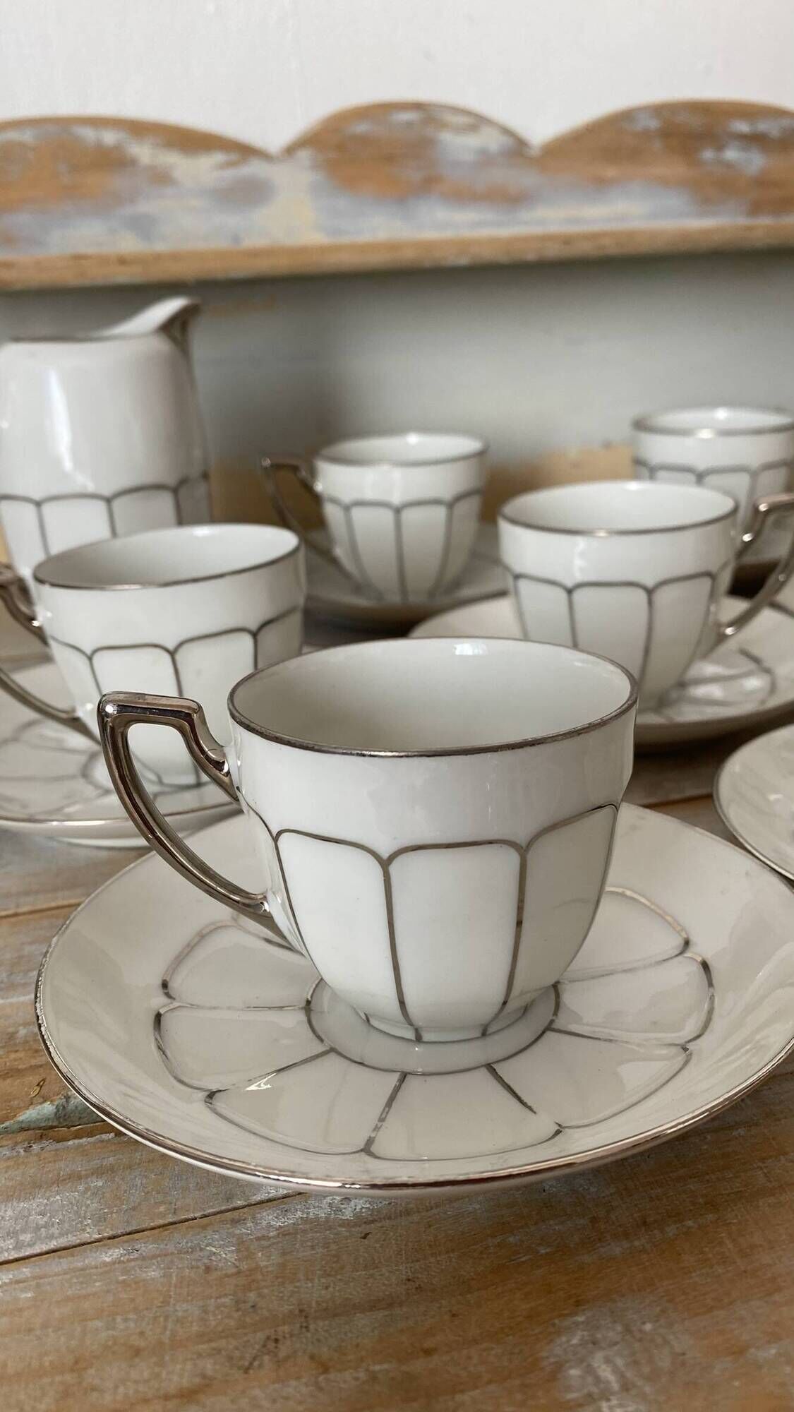 White and silver Limoges porcelain coffee cups and saucers.