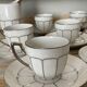 White and silver Limoges porcelain coffee cups and saucers.