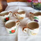 5 antique cups with liquor, porcelain fruits