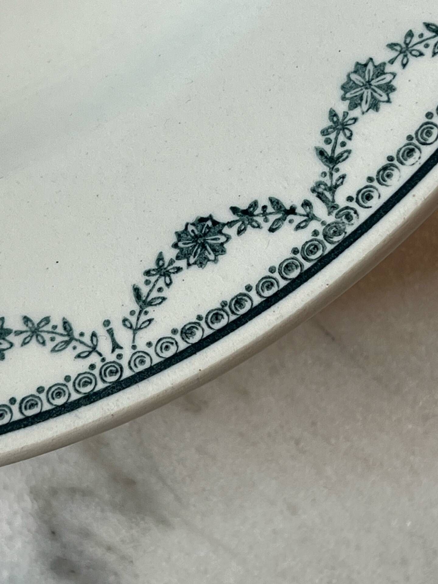 Set of 12 deep plates Saint Amand with floral garland decoration.