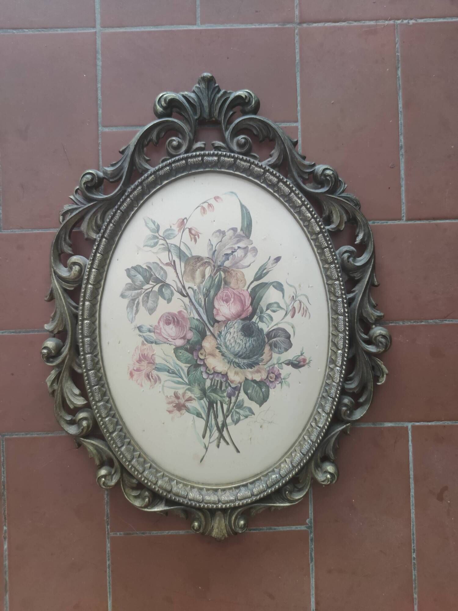 Golden brass frame with bouquet of flowers on silky fabric
