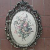 Golden brass frame with bouquet of flowers on silky fabric