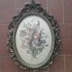 Golden brass frame with bouquet of flowers on silky fabric