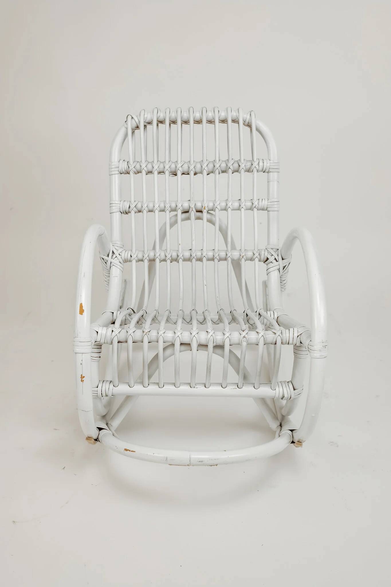 Vintage rocking chair for children in rattan/bamboo.