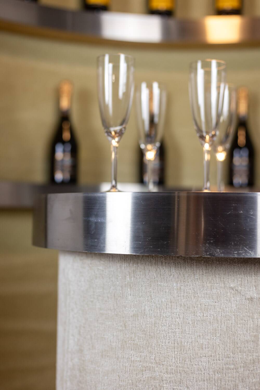 Circular bar in brushed metal, wood and carpet. 1970s.