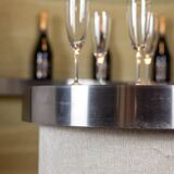 Circular bar in brushed metal, wood and carpet. 1970s.