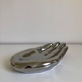 Empty silver chromed ceramic pocket in the shape of a large hand, 1980