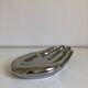 Empty silver chromed ceramic pocket in the shape of a large hand, 1980
