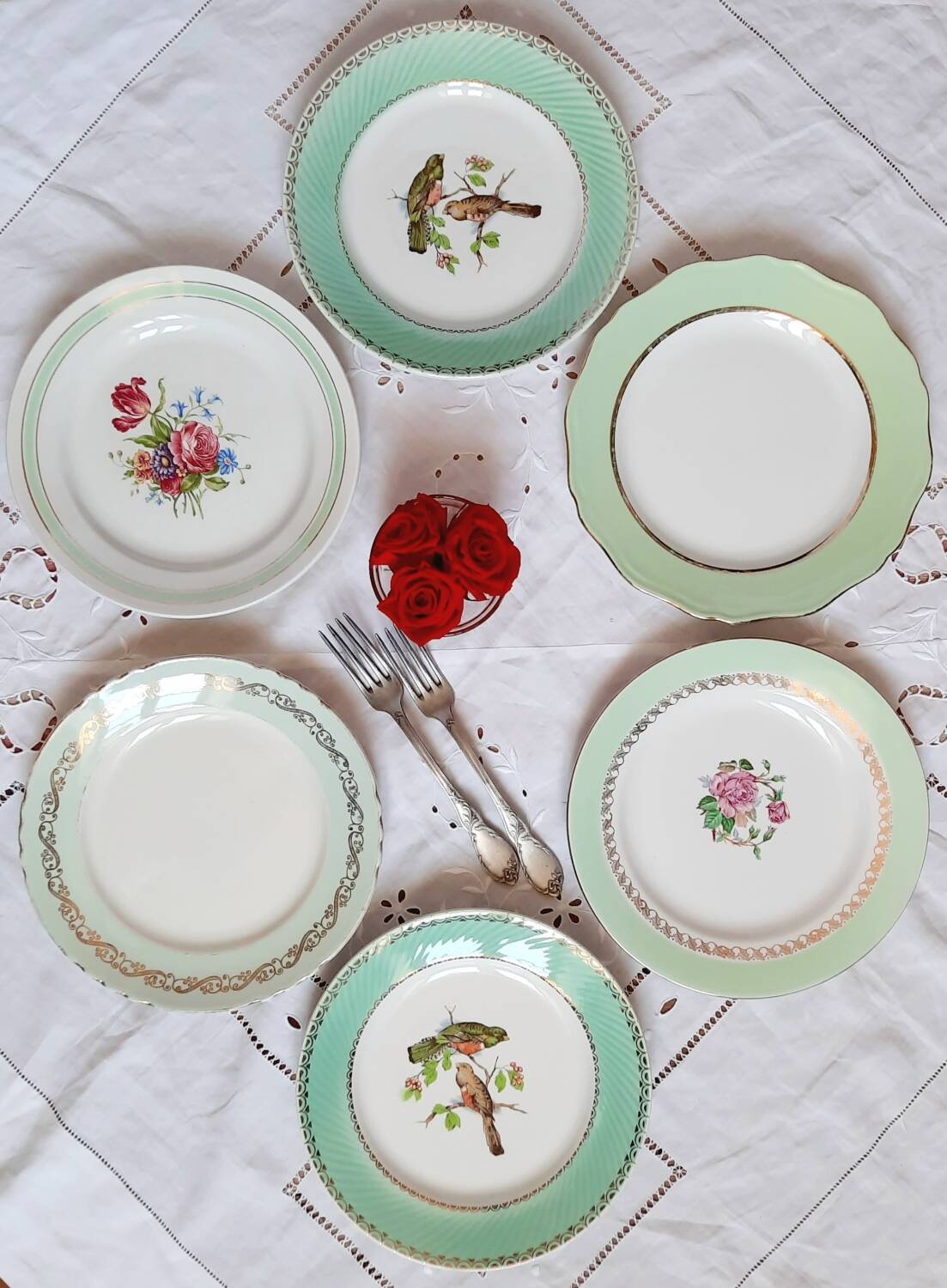 Old mismatched earthenware dinner plates with gold accompanied by a dish