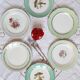 Old mismatched earthenware dinner plates with gold accompanied by a dish