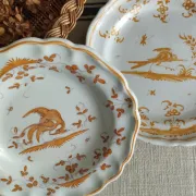Pair of antique plates with a bird of paradise design in the style of Moustiers.