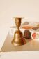 Brass candlestick in the shape of a bell.