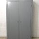 Curved wardrobe workshop locker made of wood repainted in grey.