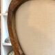 Medallion back chair in moulded wood and beige fabric.