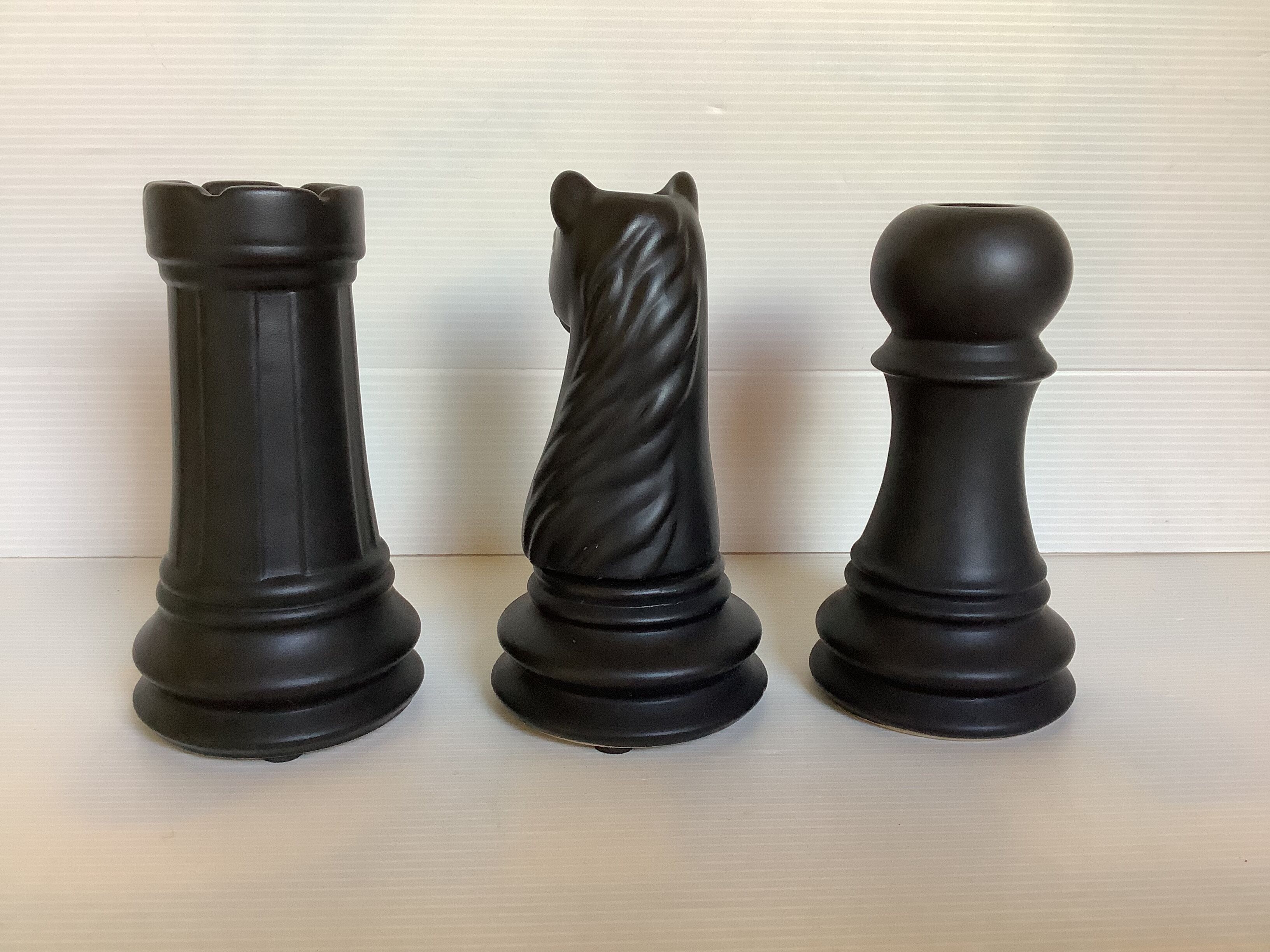 Trio of chess game candlesticks, rook, knight, pawn