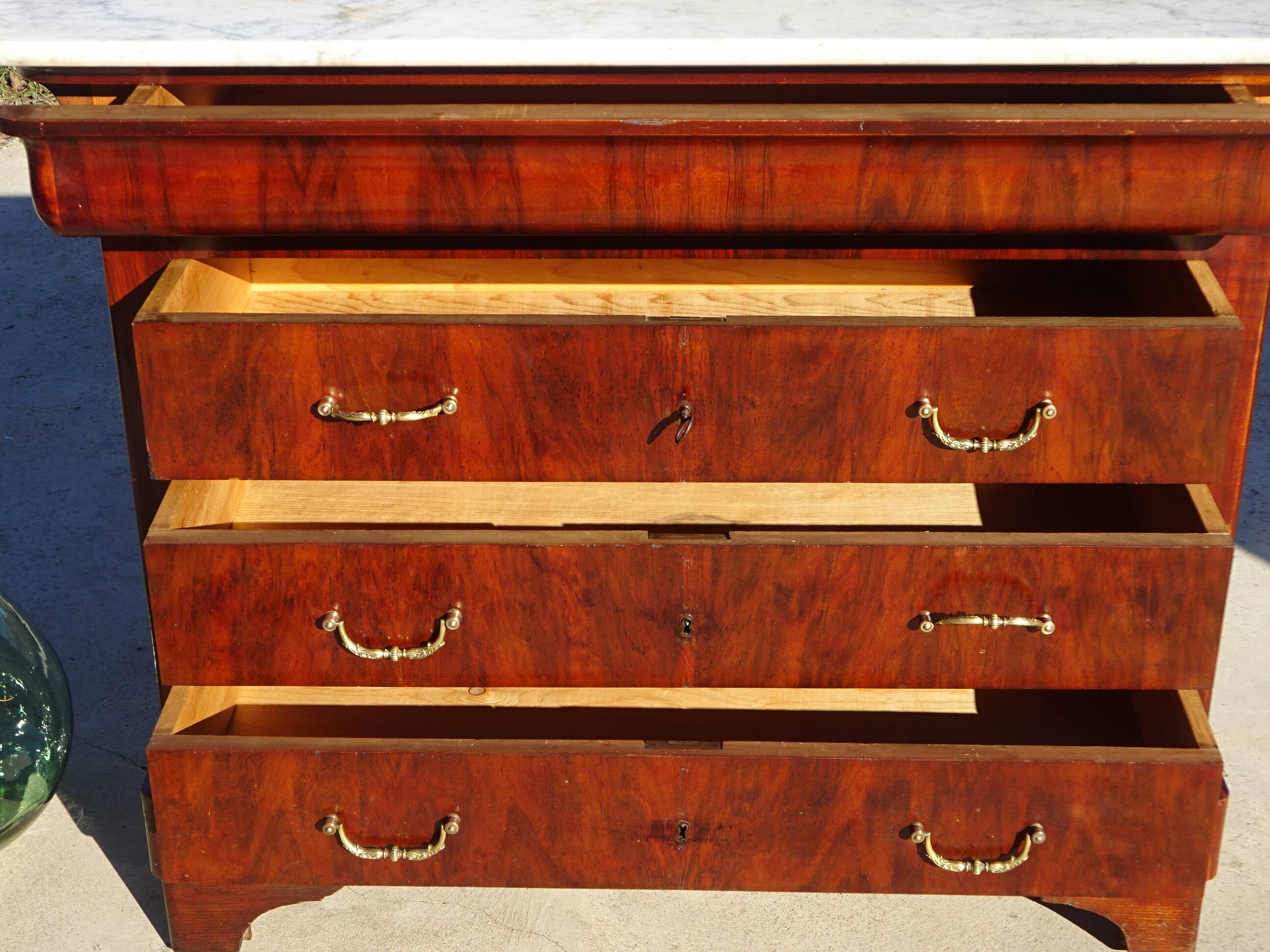 Antique mahogany chest of drawers with white marble.